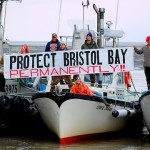 Boats with a banner reading "Protect Bristol Bay Permanently!!" held by people.