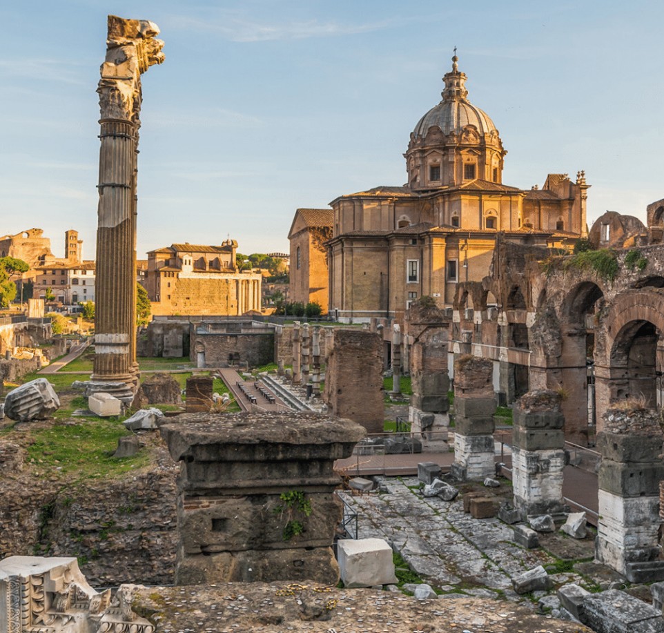 Ancient ruins with a domed building in the background, showcasing historical architecture and stone columns.